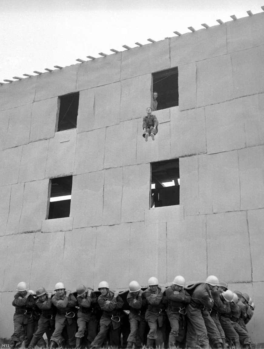 Egy tűzoltó mentőponyvába ugrik az Állami Tűzoltóság főpróbáján. (1958)