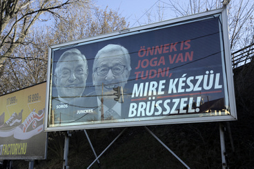 In other parts of Budapest, the posters featuring George Soros behind Jean-Claude Juncker are still untouched,