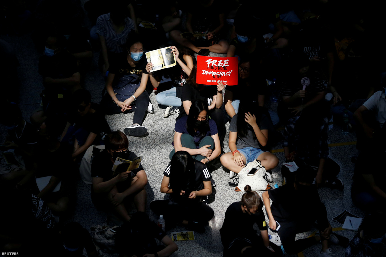 A reptér érkező oldalán megjelent tiltakozók. Múlt pénteken kezdtek ülősztrájkba tüntetők a reptéren. A helyzet egyre feszültebb lett, hétfőn végül blokádokkal megbénították a reptér forgalmát egy időre. Kedd hajnalban is 160 kimenő és 150 beérkező járatot törölt a Hongkongi Nemzetközi Repülőtér. Aznap este a hétfőinél is kaotikusabb jelenetek alakultak ki, rohamrendőrök hatoltak be a reptérre, ahol összecsaptak a tiltakozókkal. Végül aztán visszavonultak.