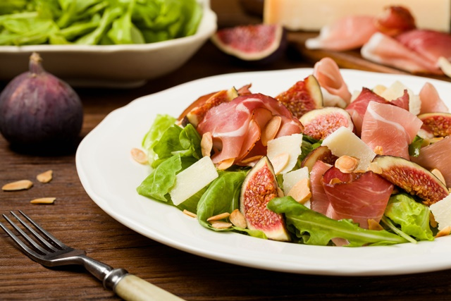 Fresh salad with figs and prosciutto with parmesan cheese and to