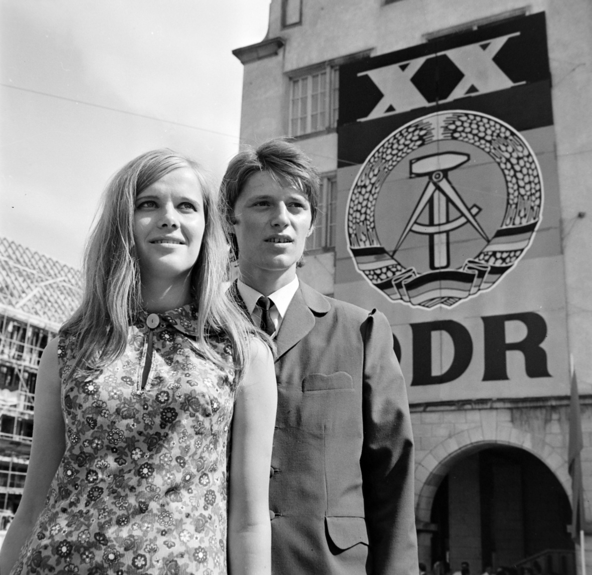 1969 - Optimistic youth at the 20th anniversary of the GDR. The young lady is wearing one of the remarkable achievements of the East German plastic industry, the synthetic fibre dress that released a spray of sparkles upon contact in the dark.