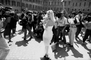 Caption:ROME ITALY - JUNE 2: The porn star in art Cicciolina candidate for the Radical Party surrounded by photographers during the election campaign for the parliamentary elections on June 2 1987 in Rome Italy.(Photo by Stefano Montesi - Corbis/Getty Images)
                        