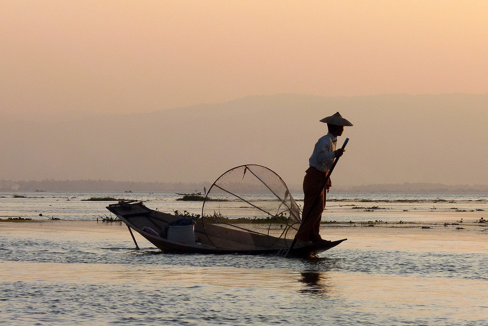 Halászat hagyományos módszerekkel az Inle-tavon. A 880 méter magasan fekvő hegyvidéki tó Burma egyik legizgalmasabb látnivalója. Mintegy százezer ember él a partvidékén és magán a vízen, ahol egész falvakat találni, templomokkal, iskolákkal, üzletekkel. A tavon élők a zöldséget a vízen úszó növényszigeteken termelik meg. 