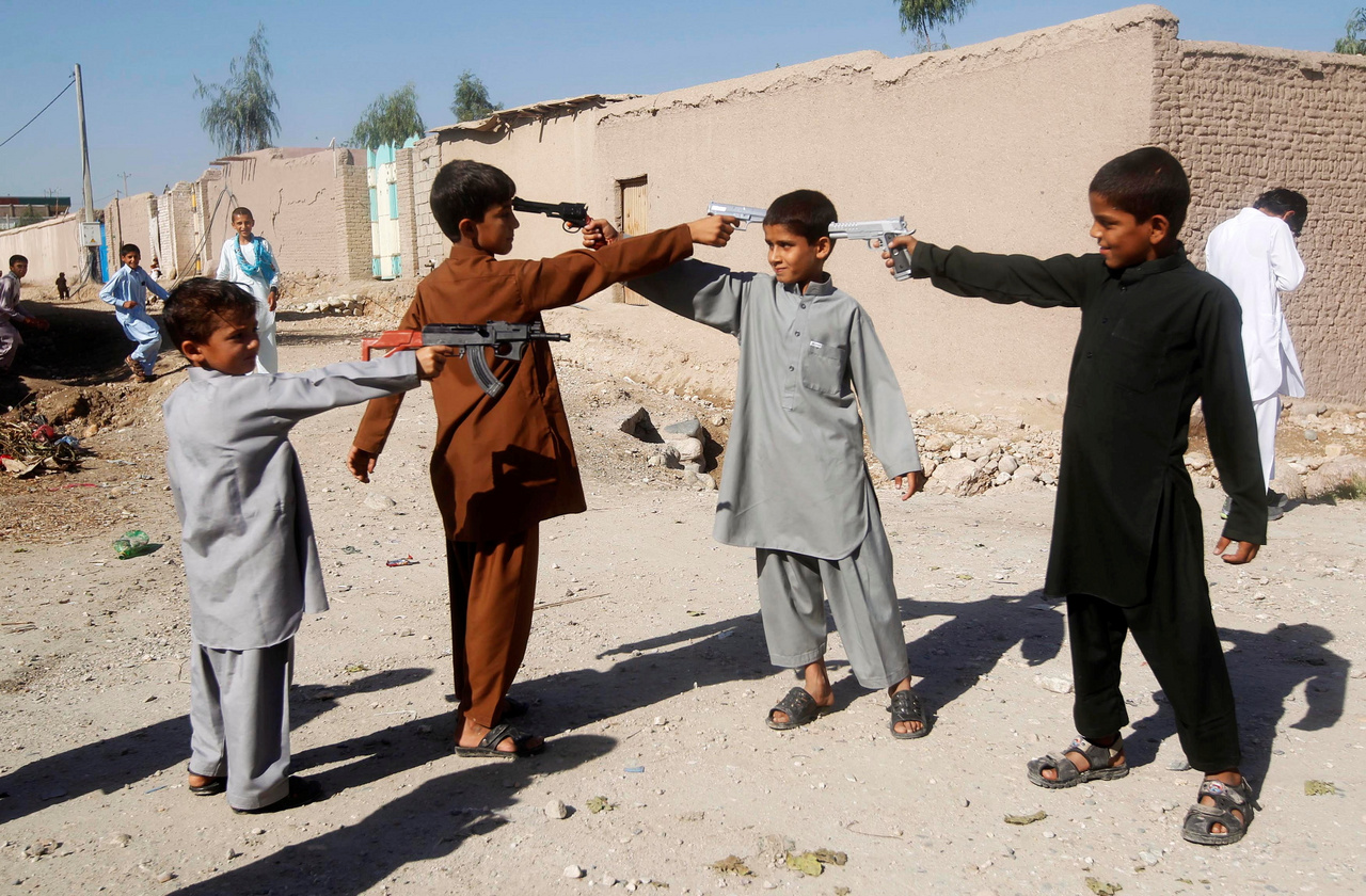 Afgán gyerekek játékfegyverekkel játszanak Íd al-Adhá, vagyis az áldozati ünnep első napján. 
                        Dzsalálábád, 2013. október 15.
