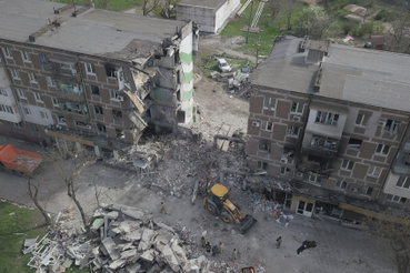 Mentők dolgoznak egy támadásban megrongálódott lakóépültnél Mariupolban 2022. április 19-én