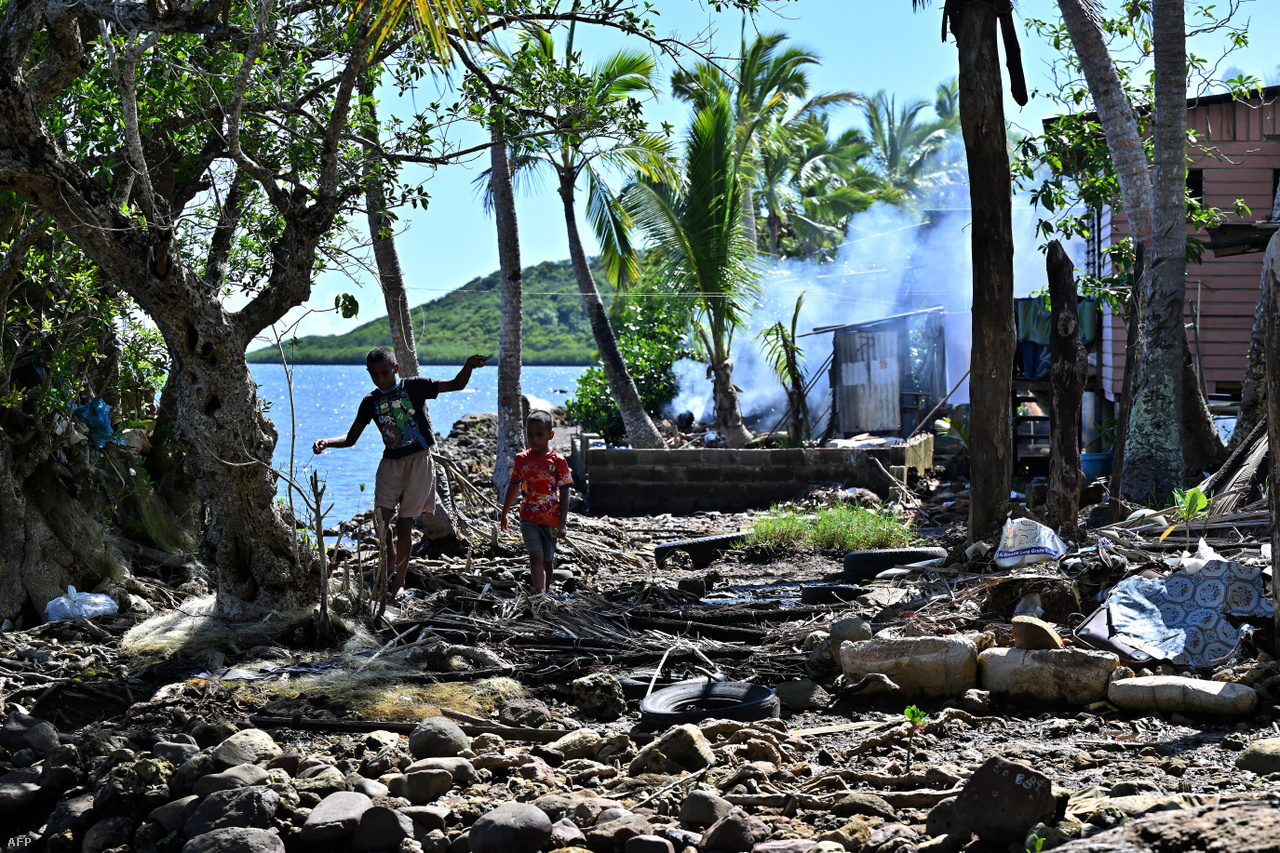 Gyerekek tengerparti házuk előtt, amelyet szintén pusztulással fenyeget a tengeri erózió Veivatuloa településen. 